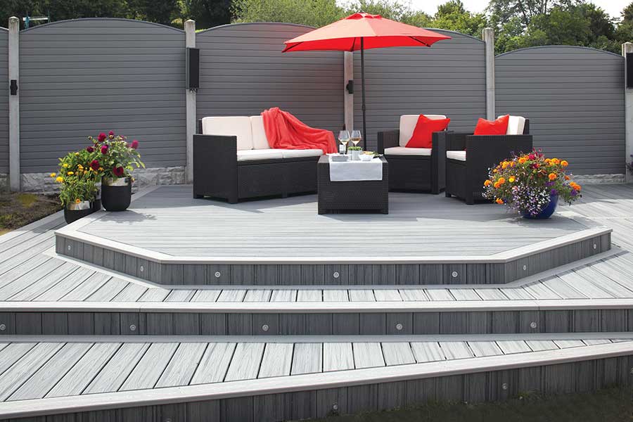 Trex Transcend Island Mist grey wood effect composite decking in a modern garden setting